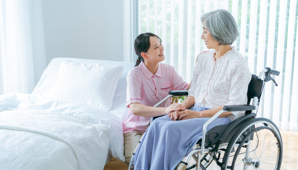 Senior woman and young caregiver living in a nursing home