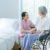 Senior woman and young caregiver living in a nursing home