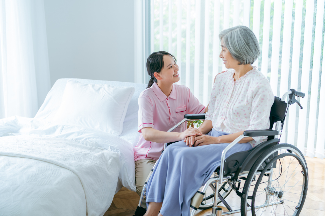 Senior woman and young caregiver living in a nursing home